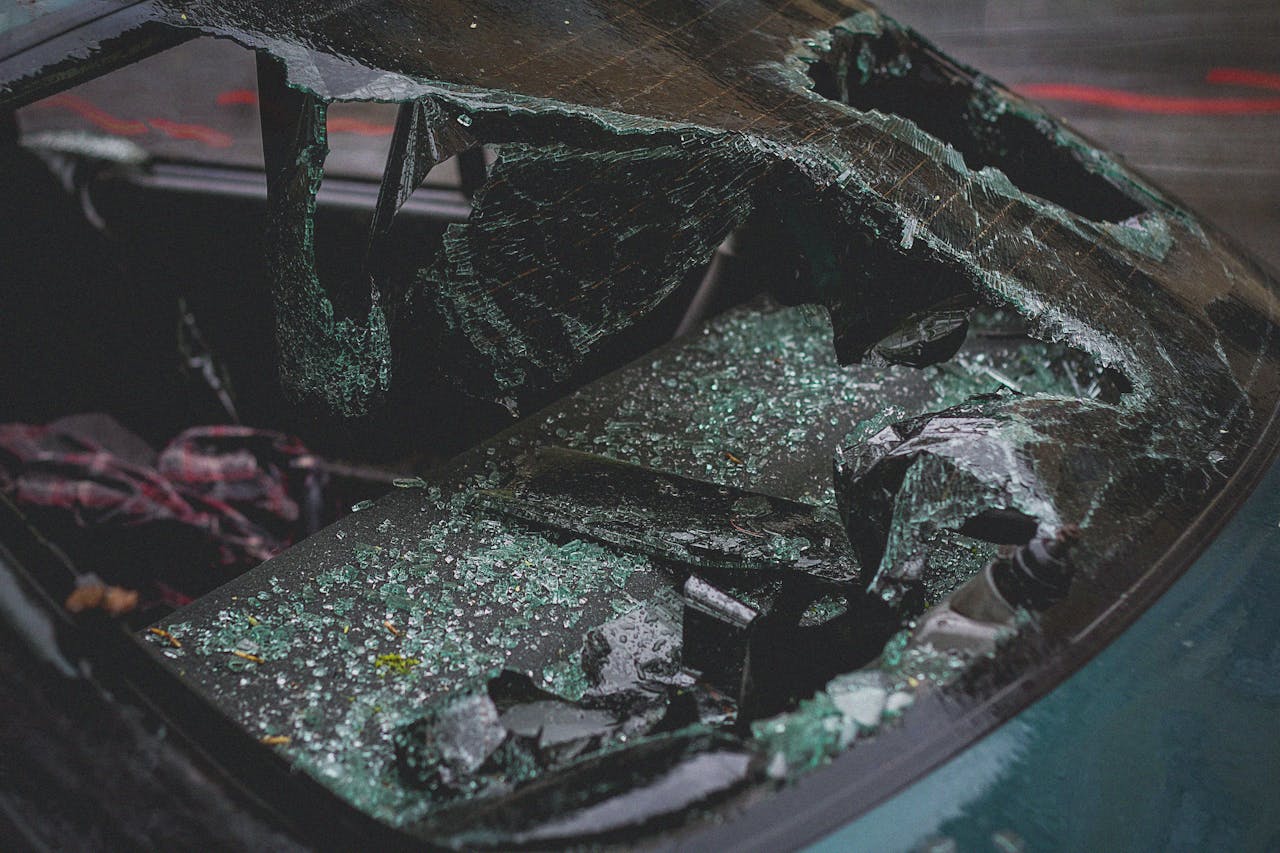 services-02 Detailed view of shattered car windshield after accident, emphasizing damage and broken glass.